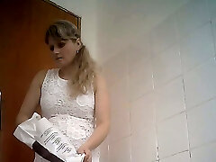 Fine curvaceous blonde lady in white dress filmed in the toilet bedroom