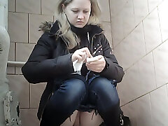 Succulent pale skin blonde teen in blue jeans urinates in the toilet