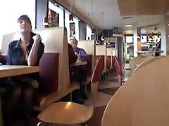 Brunette MILF flashing her bra-stuffers in a restaurant