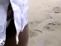 Chinese bodybuilder barely covered at the beach