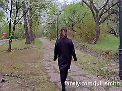 Sizzling girl in a very short dress walks in the park and flashes her pussy