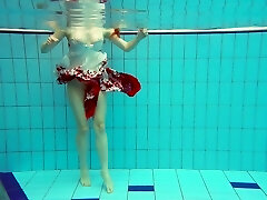 Sizzling redhead model Marketa swimming bare in a pool
