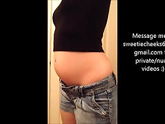 Stuffed swollen belly in tight clothes