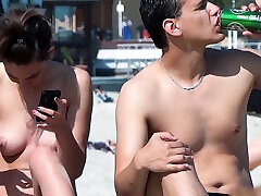 Playful young nudis girlt has fun at the beach