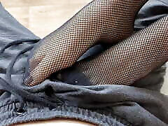 Girl in black fishnet tights seduces guy and lets him cum on her feet