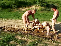 Two fat blonde grannies fucked in the mud by young guys outdoors
