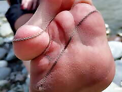 Goddess In Tan Nylons Show Her Cute Nylon Soles And Toes On The Riverside
