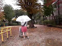 A woman soaked in the rain, wetting her pussy.