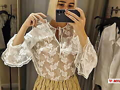 Trying on transparent clothes in the fitting room. Naked blonde flashed her boobs in a public place
