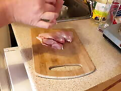 Zara is cooking topless in the kitchen