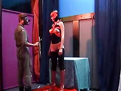 Masked German slut sucks dragon lily footjob and drinks cum after BDSM action