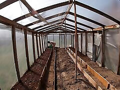 Nude house wife working in the greenhouse