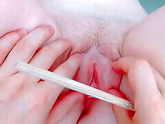 penetrating her with a thin straw between her lips and tight pussy
