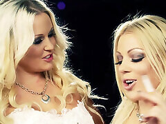 Blonde MILFs touch each other and kiss while holding cigarettes