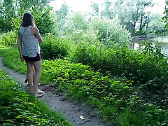 Two girls stopped on the side of the road to pee, attracting the attention of passing cars, golden shower in a public place