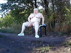 Mother-in-law in the park undresses and masturbates to orgasm on a bench