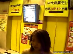 Smiling Asian girl using the pad knows what this man wants from her