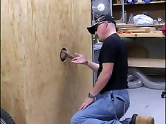 Guy sucks off dong through a hole