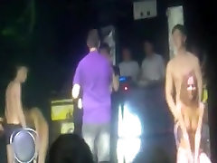 2 russian couple have a pinex down game on stage in a disco