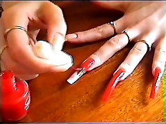Long natural nails red polishing