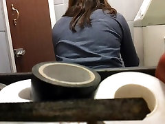 Brown-haired lass back shots while sitting on throne