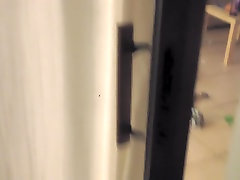 Girl in the window is sitting naked on the sofa