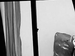 Sexy neighbor getting naked in the open window