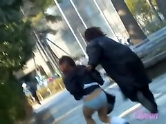 Asian babe gets embarrassing skirt sharking in a public park.