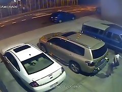 Security camera catches a girl peeing behind a car