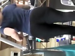 Tattooed woman running in treadmill