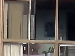 Naked mature spied through her apartment window