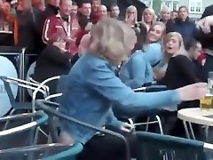 Drunk woman pissing on a bar terrace