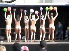 Naked ladies dance on stage with balloons