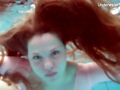 Long haired Simonna is ready to expose her natural pale tits underwater