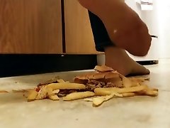 Cheeseburger winking daisy fries crushed under nylon feet, walkover style