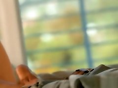 Sexy Natasha propped up on his pillow