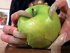 scratching an apple long nails