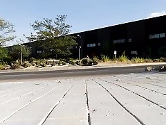 naked in the street near a building