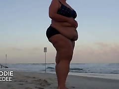 BBW walks and poses on public beach