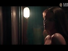 Romantic and sexy Emilia Clarke flashes her nice titties in one of the movies