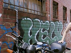 Hot busty blonde lesbian gets licked next to her motorbike