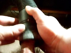 while his wife works, he uses a vacumn hose to get off