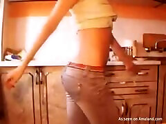 Hot blonde girl posing and dancing in the kitchen