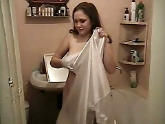 Gorgeous young white hottie proudly shows her breasts and pisses in the bathtub