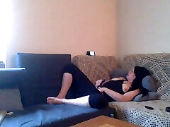 Lustful brunette flatmate masturbating on a couch
