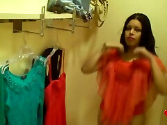 Curvy stunner trying on sexy dress in a changing room