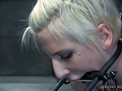 Chained and spread blondie with a metal bar between her teeth