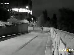 White girl in the dark bends over and flashes her ass while urinating