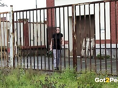 Quite curvy amateur black head gonna pee outdoors near the metal fence