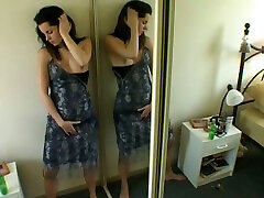 Delicious young brunette pleasing her pussy in front of a mirror